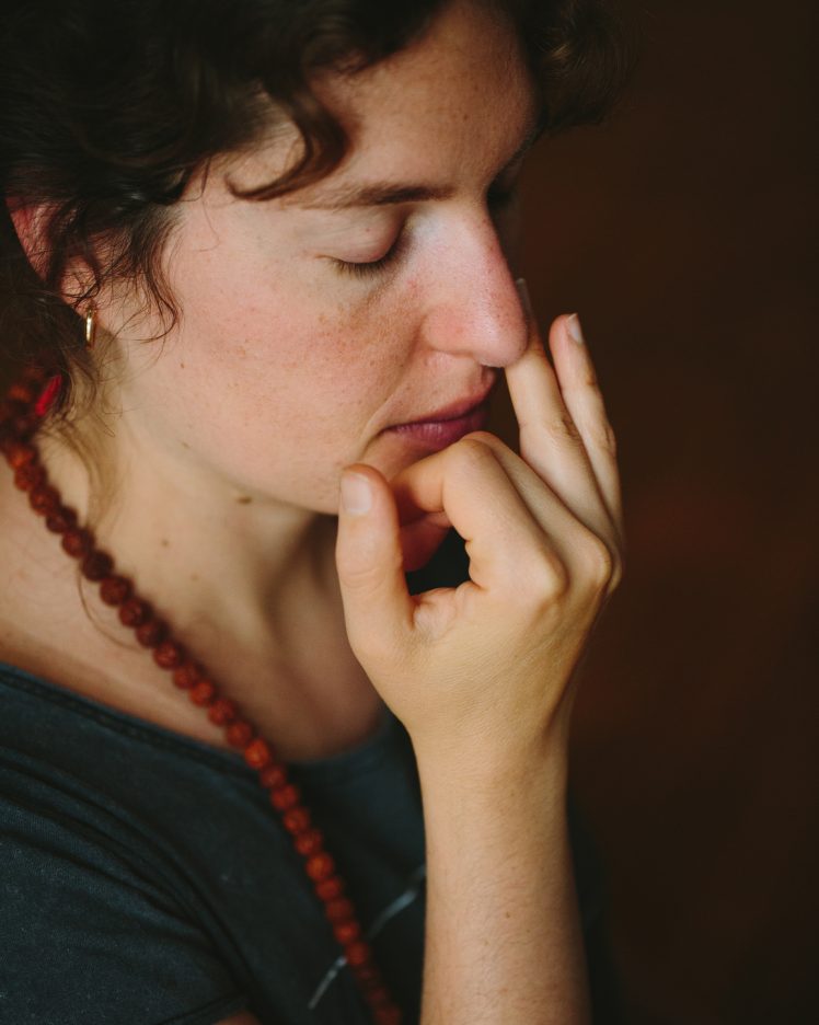 a close up of a person doing a calming breathing exercise.
